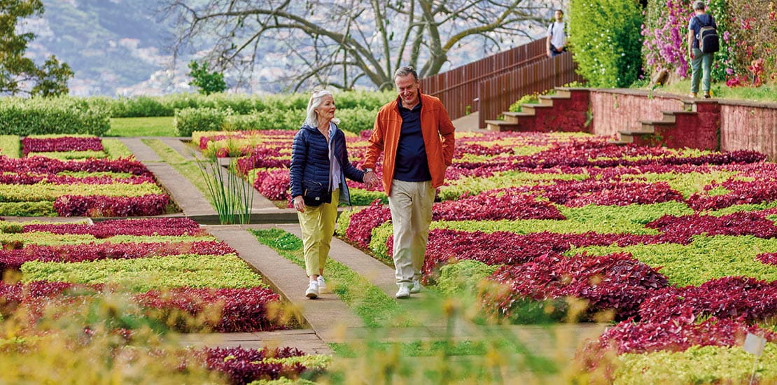 A couple walking through the Botanical Gardens in Funchal, Madeira